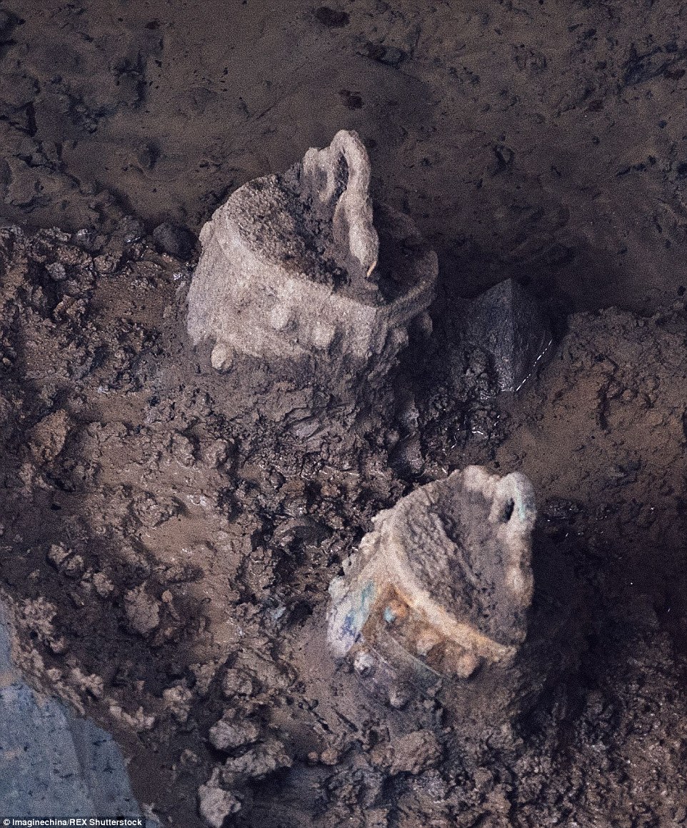 Relics: In another tomb, the largest in the area, archaeologists also discovered copper (pictured) bells and copper ceremonial pots