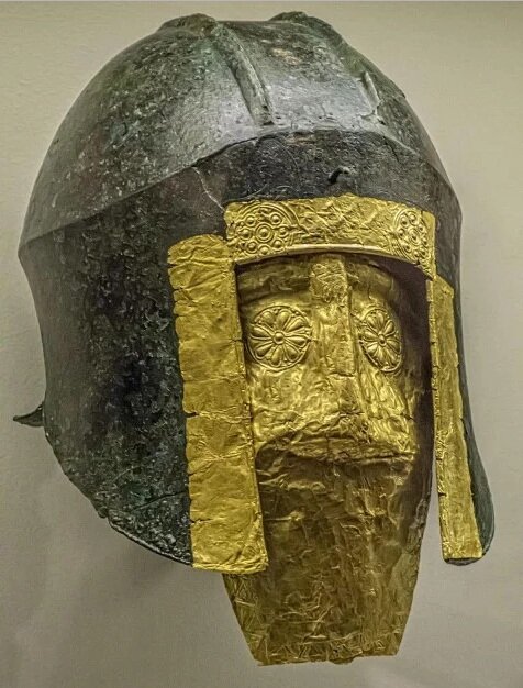  Funerary bronze helmet with gold mask from the necropolis at Archontiko Grave 279 Greek mid 6th century BCE. This warrior’s grave also included a bronze shield, iron swords, spear points, gold ornaments, a chariot model, figures, and more. This is o