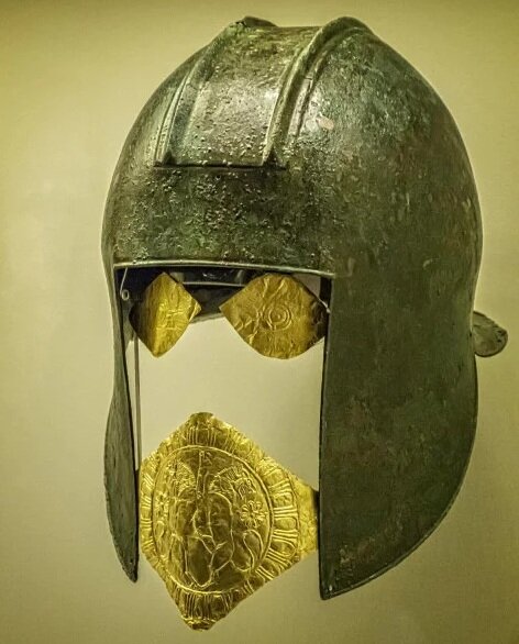 Funerary bronze helmet with gold eye and mouth pieces from the necropolis at Archontiko Greek 550-525 BCE. Lacking any decoration apart from the crest, this is one of the simplest helmets found in the necropolis of Archontiko. The two embossed heral