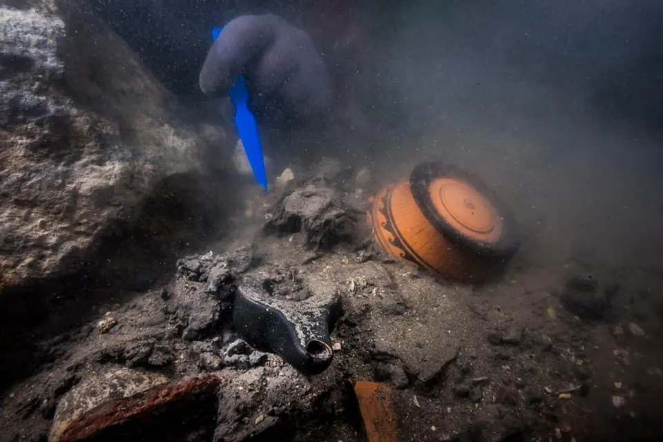 Marine archaeologists examining a colossal marble head of the Greco-Egyptian god Serapis at Thonis-Herakleion