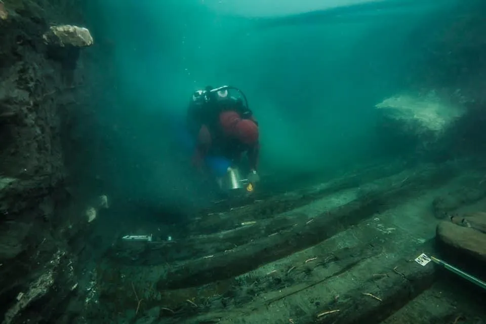 Marine archaeologists examining a colossal marble head of the Greco-Egyptian god Serapis at Thonis-Herakleion